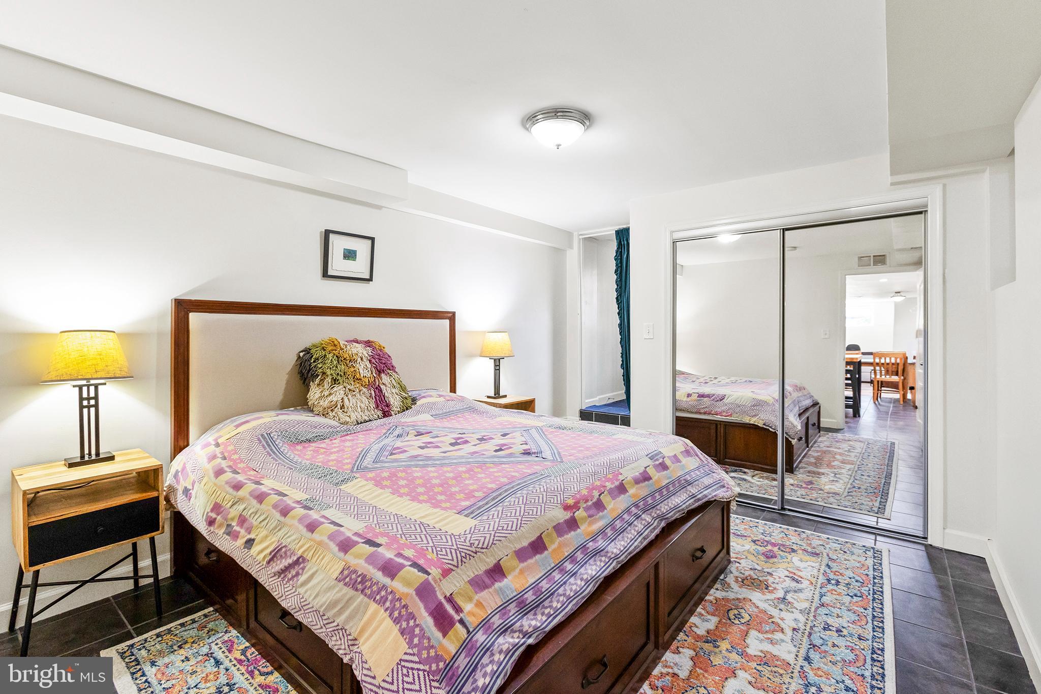 36 Quincy Place Northeast Washington, DC 20002 - Photo 27 of 29 a bedroom with a bed a lamp and a rug