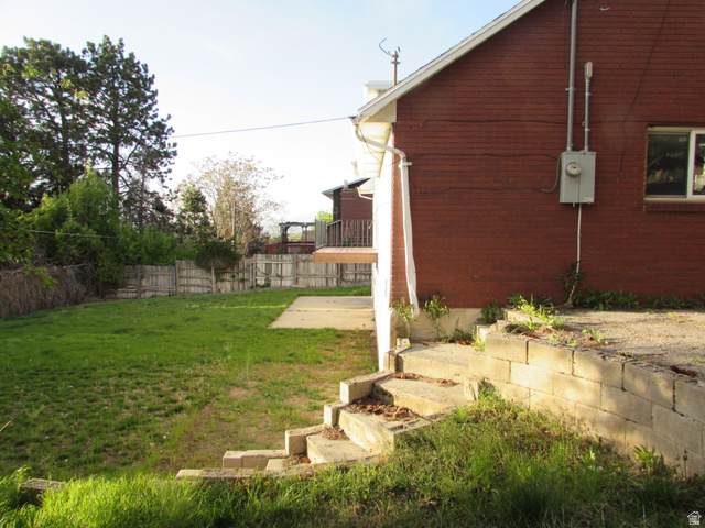 3166 Linden Street Bountiful, UT 84010 - Photo 22 of 25 Fenced backyard featuring a patio with wooden balcony off the kitchen