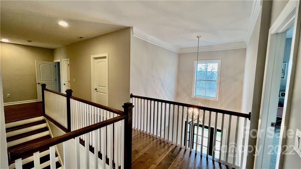 2250 Watermark Point Place, Unit 83 Fort Mill, SC 29708 - Photo 13 of 23 a view of a hallway with wooden floor and stairs