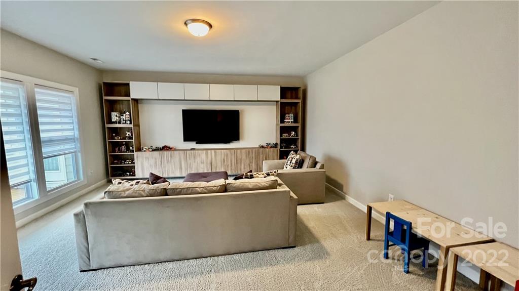 2250 Watermark Point Place, Unit 83 Fort Mill, SC 29708 - Photo 14 of 23 a living room with furniture and a flat screen tv