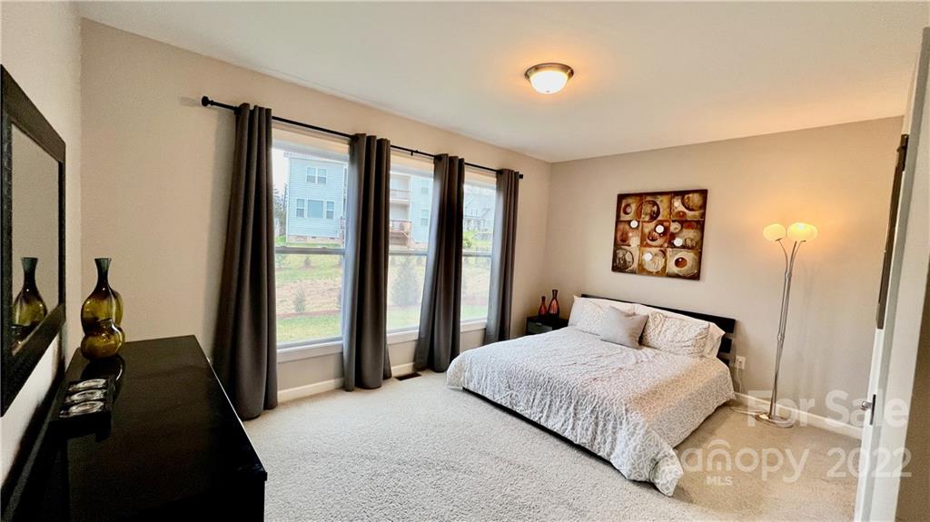 2250 Watermark Point Place, Unit 83 Fort Mill, SC 29708 - Photo 16 of 23 a bedroom with a large bed and a large window