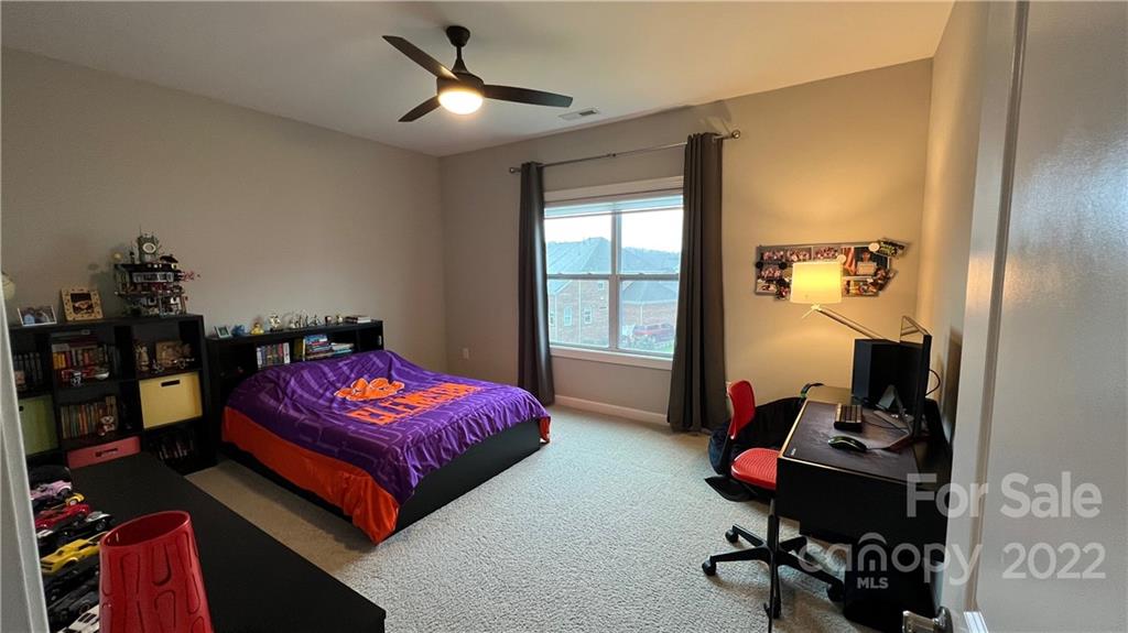 2250 Watermark Point Place, Unit 83 Fort Mill, SC 29708 - Photo 6 of 23 a bedroom with bed and a chandelier