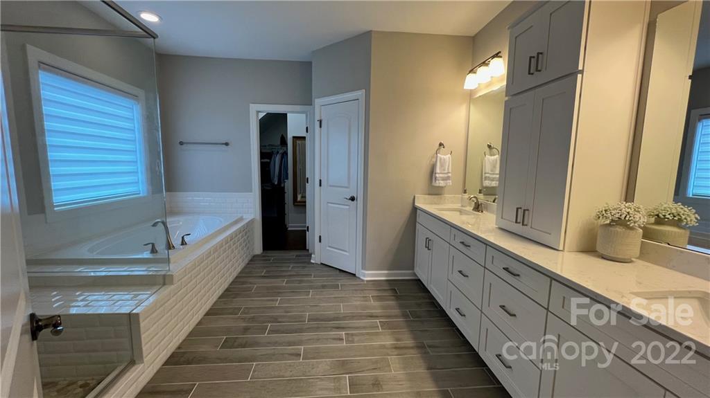 2250 Watermark Point Place, Unit 83 Fort Mill, SC 29708 - Photo 7 of 23 a spacious bathroom with a double vanity sink and a large mirror
