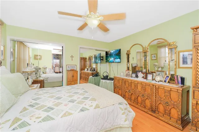 a large bedroom with a bed and glass windows