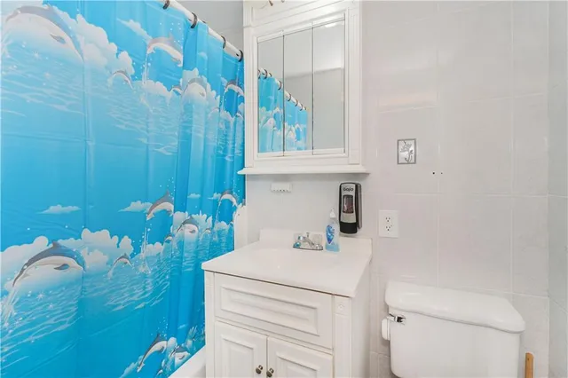 a bathroom with a sink toilet and granite