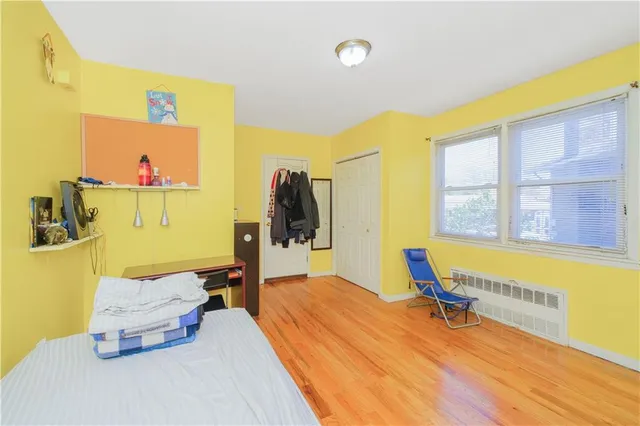 a bedroom with a bed and a large window