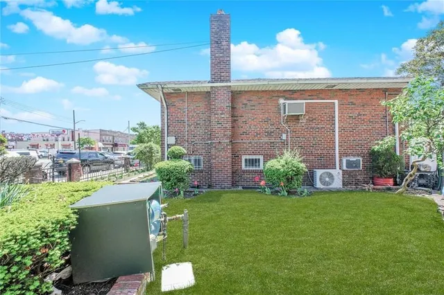 a view of a house with a backyard and a tree