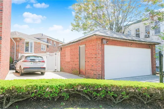 a backyard of a house with a garden and tree