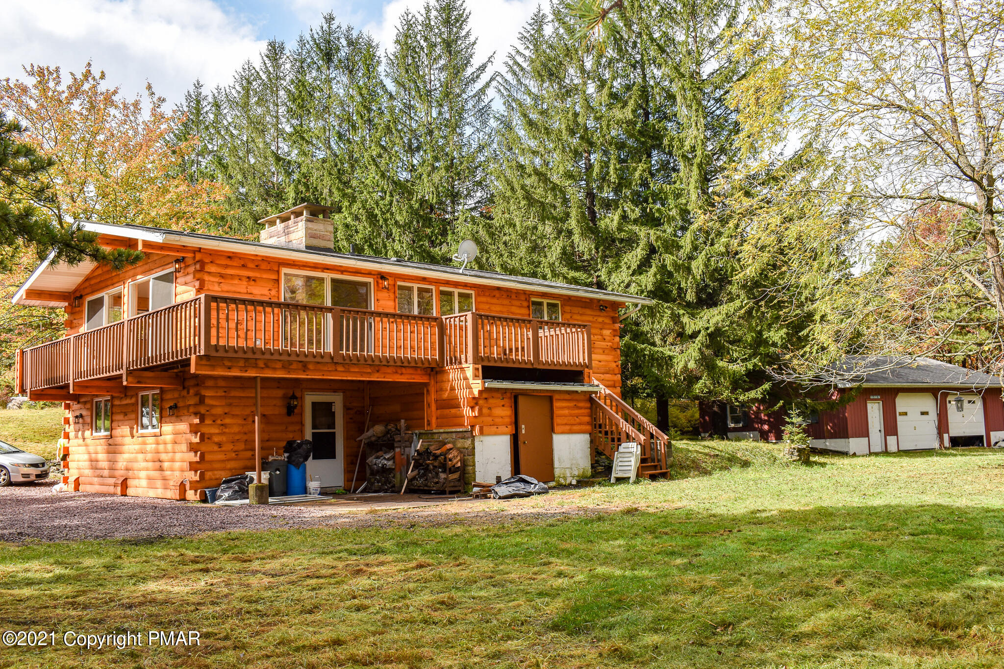 207 Sage Road Long Pond, PA 18334 - Photo 5 of 28 a front view of a building with a garden and trees