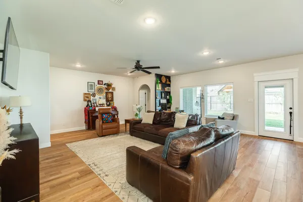a living room with furniture and wooden floor