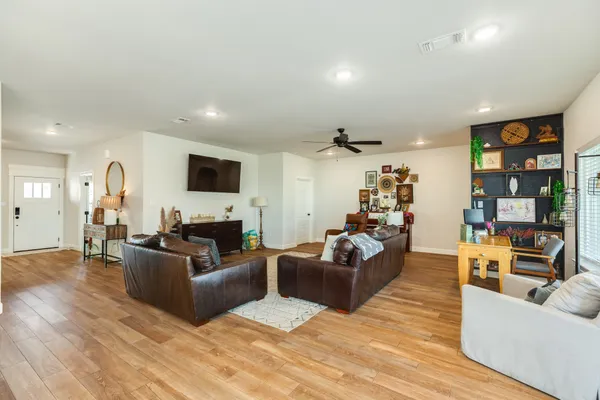 a living room with furniture flat screen tv and couches
