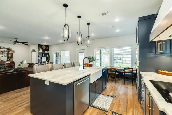 a kitchen with counter space appliances and a ceiling fan