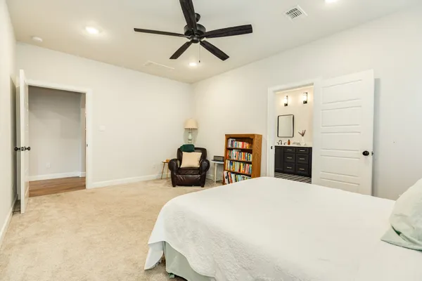 a bedroom with a bed and ceiling fan