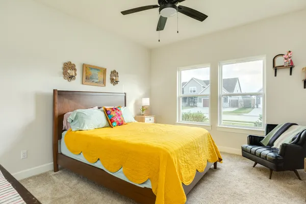 a bedroom with a bed and glass window