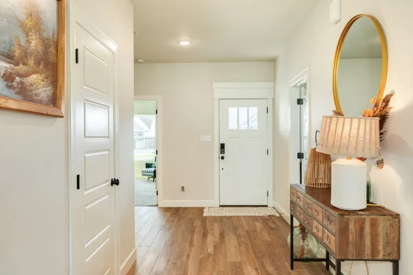 a view of a livingroom with wooden floor and furniture