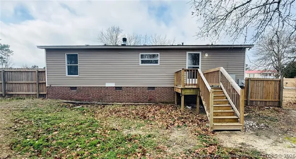 a view of a house with a wooden deck