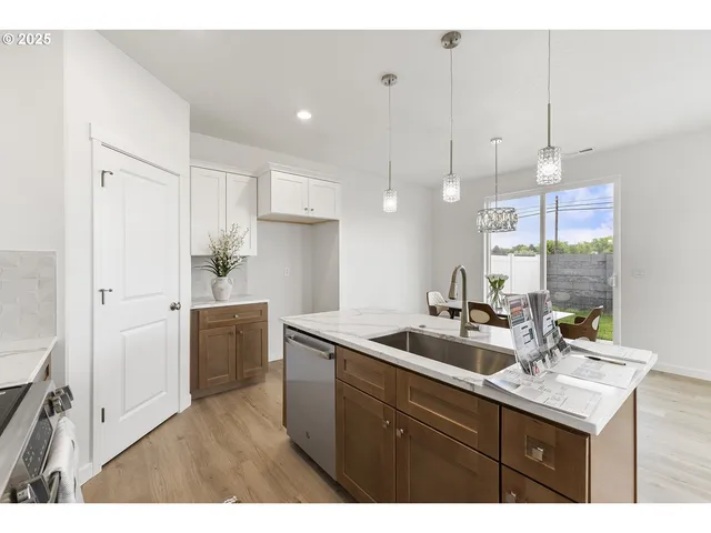 a kitchen with a sink a counter space and appliances