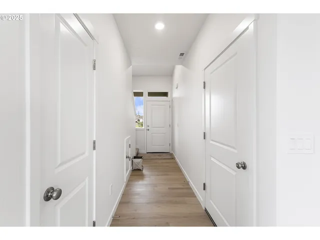a view of a hallway with a white walls