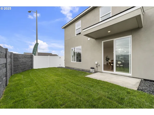 a view of a backyard with plants and a garden