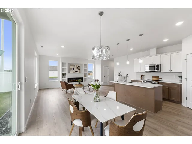 a kitchen with kitchen island a stove a table and chairs