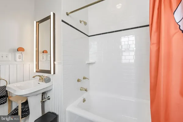 a bathroom with a sink a toilet and a shower