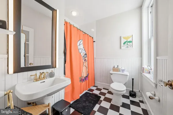 a view of a bathroom with a shower and a mirror