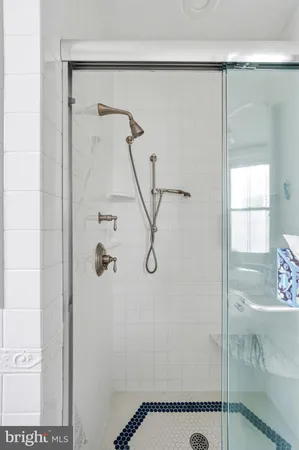 a bathroom with a sink mirror toilet and shower