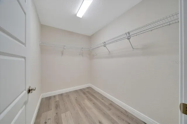 a view of a room with wooden floor