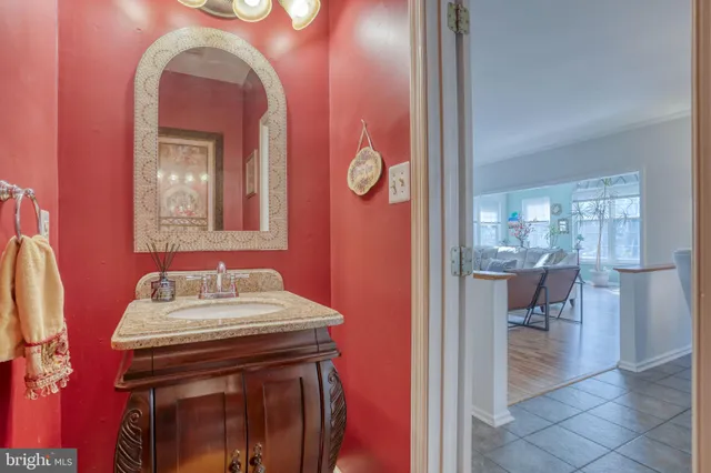 a view of a hallway with wooden floor and stairs