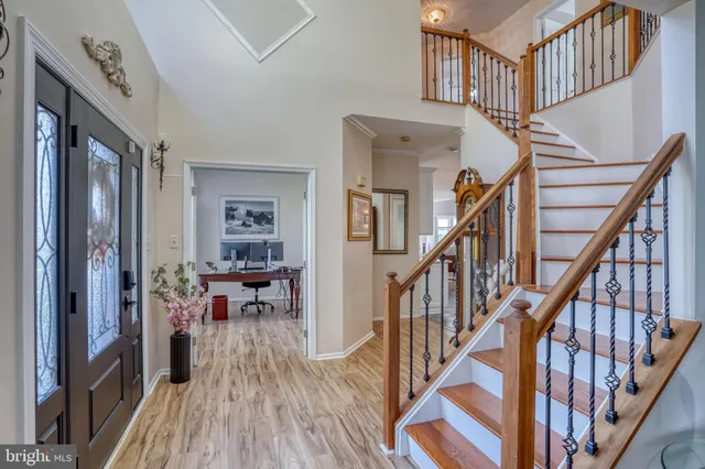 a view of entryway livingroom and hall with wooden floor