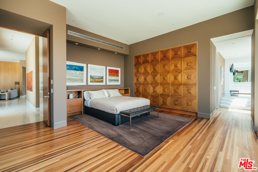 1470 Carla Ridge Beverly Hills, CA 90210 - Photo 11 of 44 a bedroom with a bed and wooden floor
