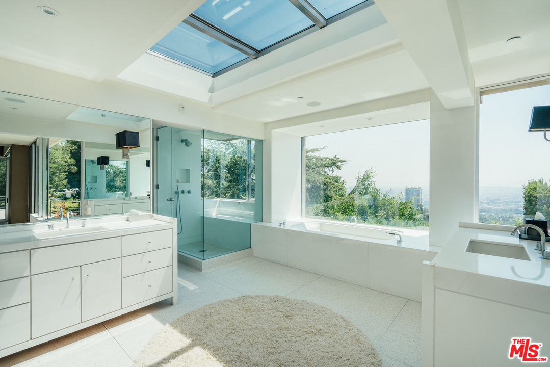 1470 Carla Ridge Beverly Hills, CA 90210 - Photo 18 of 44 a large white tub sitting in a bathroom next to a window