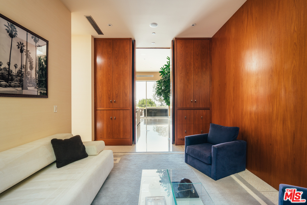1470 Carla Ridge Beverly Hills, CA 90210 - Photo 27 of 44 a living room with furniture and a window