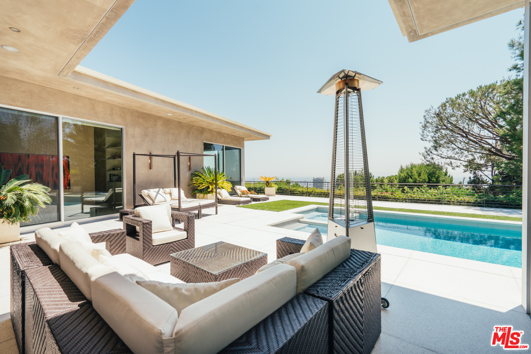 1470 Carla Ridge Beverly Hills, CA 90210 - Photo 32 of 44 a view of an outdoor dining space with a table and chairs