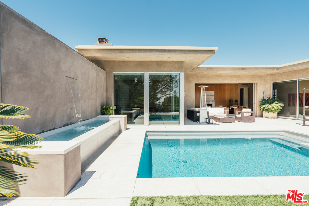 1470 Carla Ridge Beverly Hills, CA 90210 - Photo 36 of 44 a living room with furniture and a large window