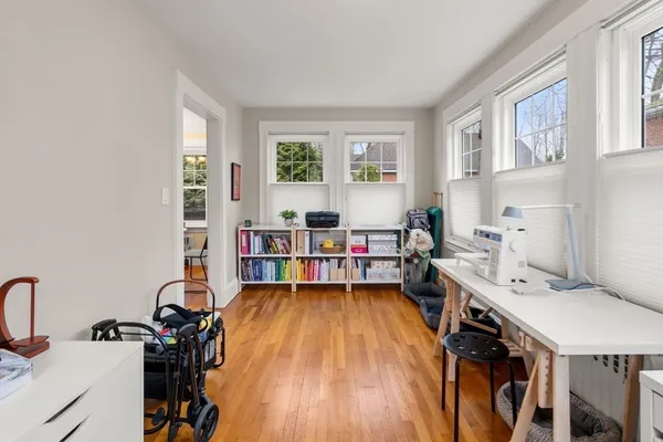 a view of a workspace with furniture and a window