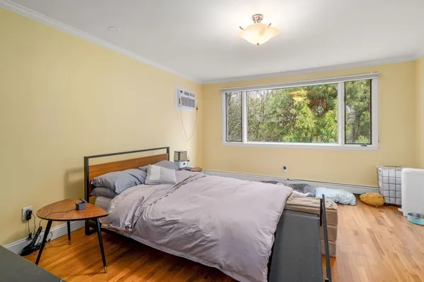 a bedroom with a bed and window