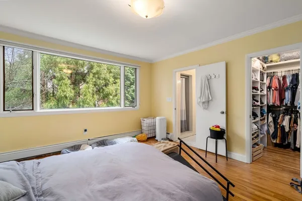 a bedroom with furniture and a window