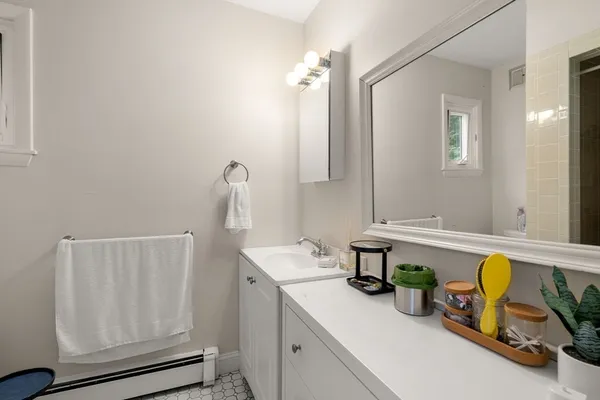 a bathroom with a sink a toilet and mirror