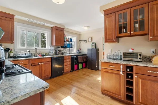 a kitchen with stainless steel appliances granite countertop sink stove and cabinets