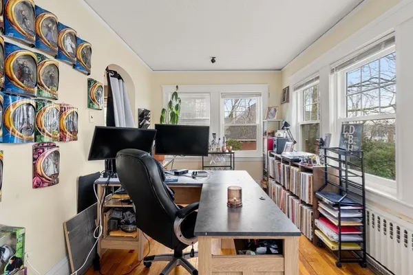 a view of a workspace with furniture and a window
