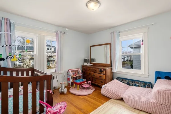 a bedroom with furniture toys and a window
