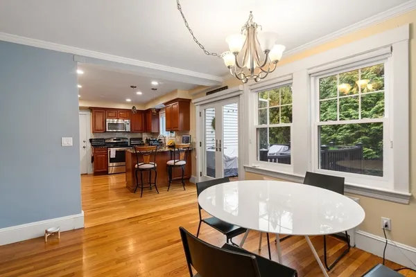 a living room with dining table a table and kitchen view