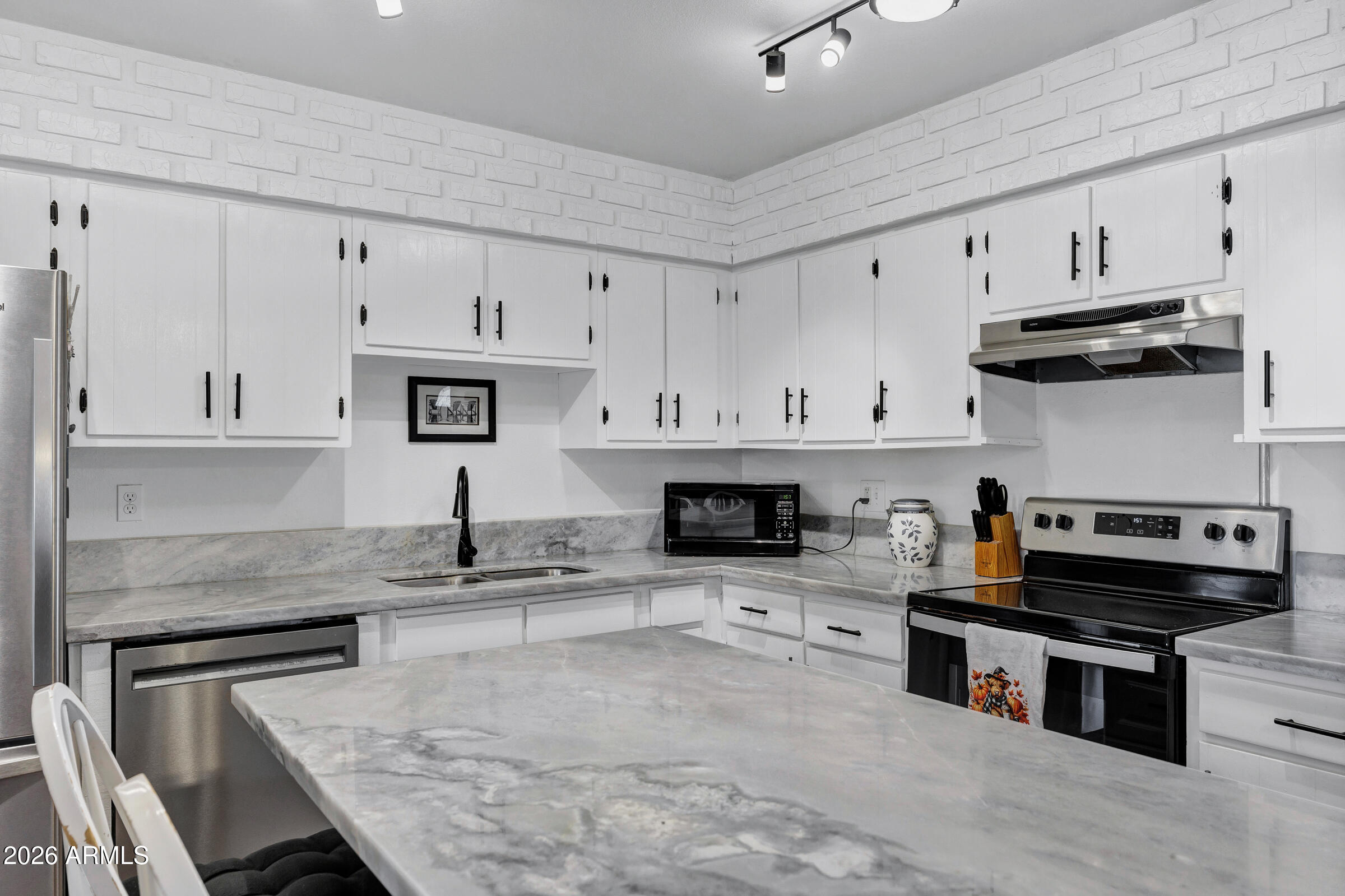 6618 North Evans Road Coolidge, AZ 85128 - Photo 11 of 48 a kitchen with stainless steel appliances granite countertop a stove and a sink