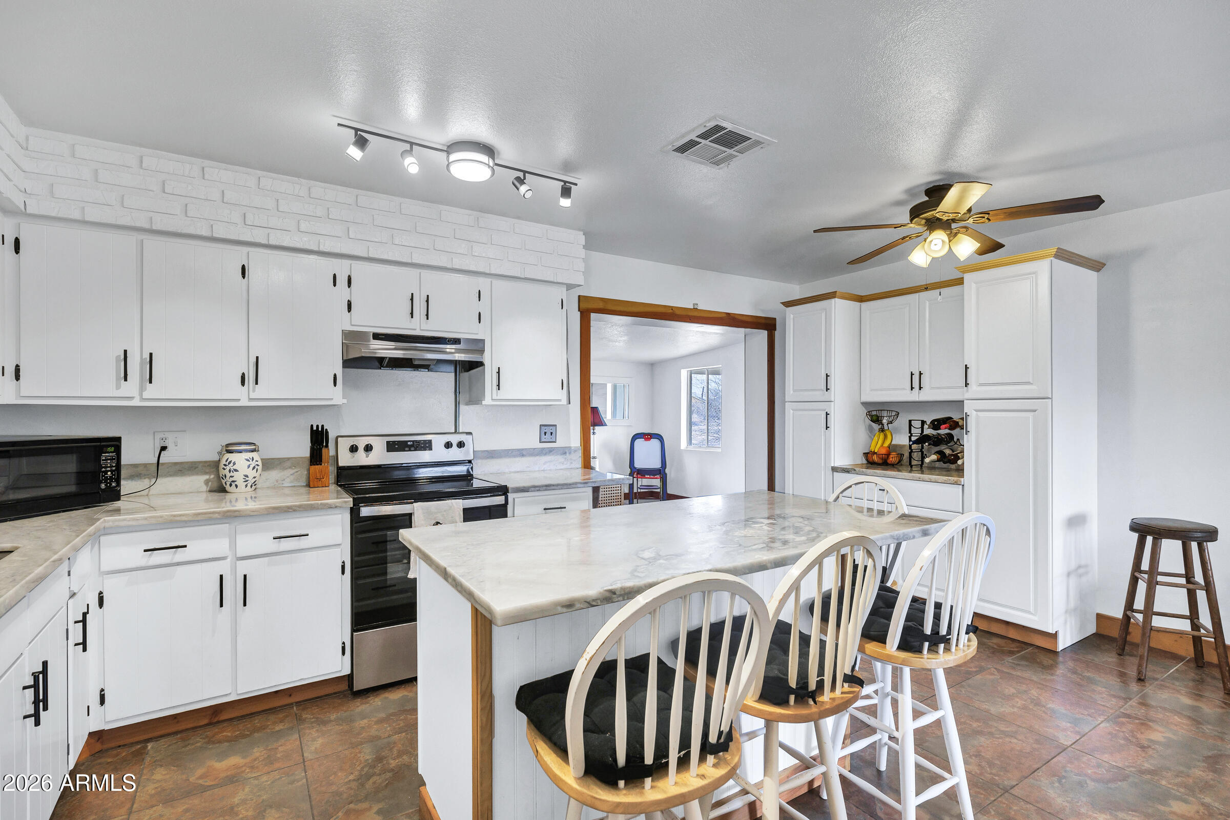 6618 North Evans Road Coolidge, AZ 85128 - Photo 13 of 48 a kitchen that has a lot of cabinets in it and appliances