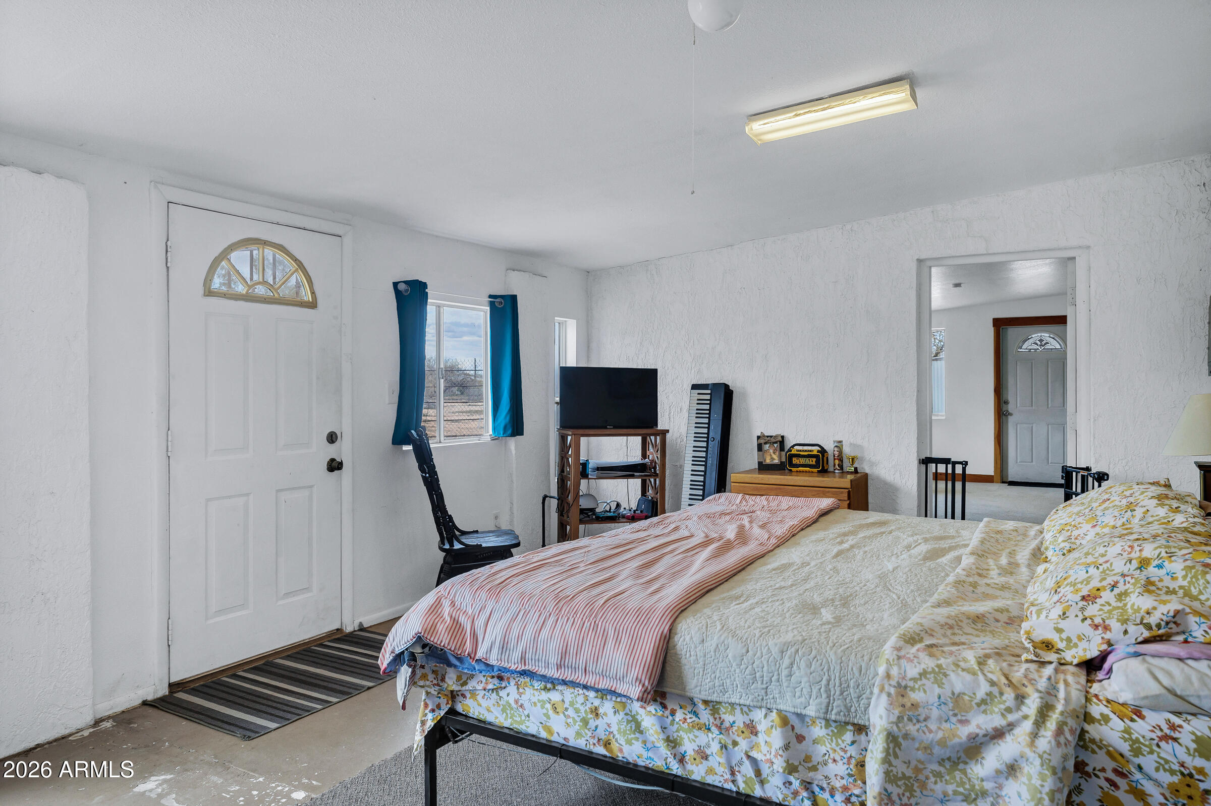 6618 North Evans Road Coolidge, AZ 85128 - Photo 21 of 48 a bedroom with a bed and a flat screen tv
