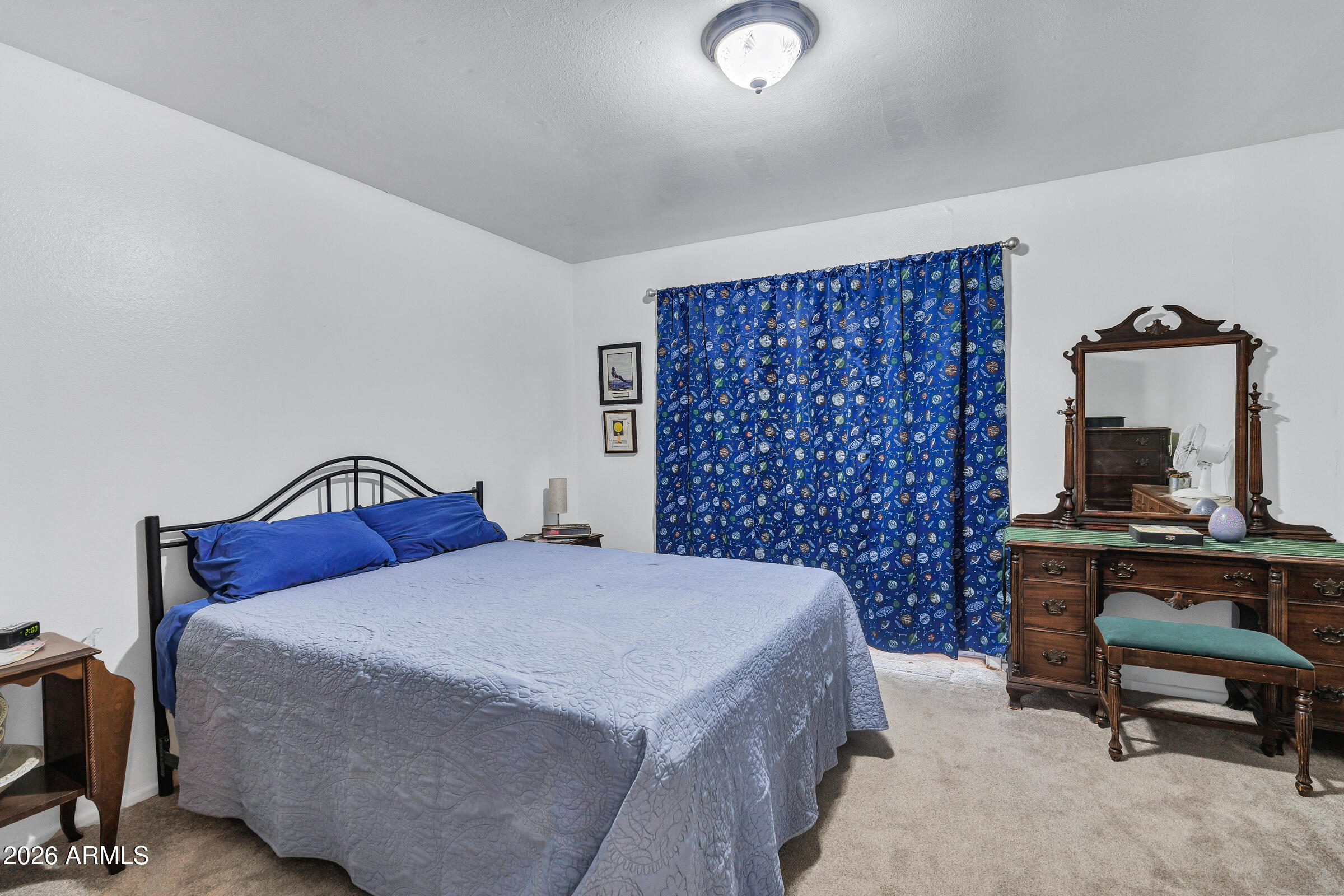 6618 North Evans Road Coolidge, AZ 85128 - Photo 23 of 48 a bedroom with a bed and a chair