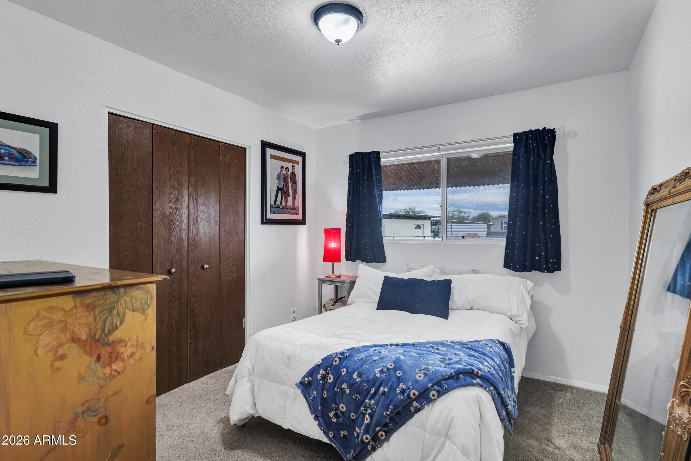 6618 North Evans Road Coolidge, AZ 85128 - Photo 24 of 48 a bedroom with a large bed and a flat tv screen on dresser