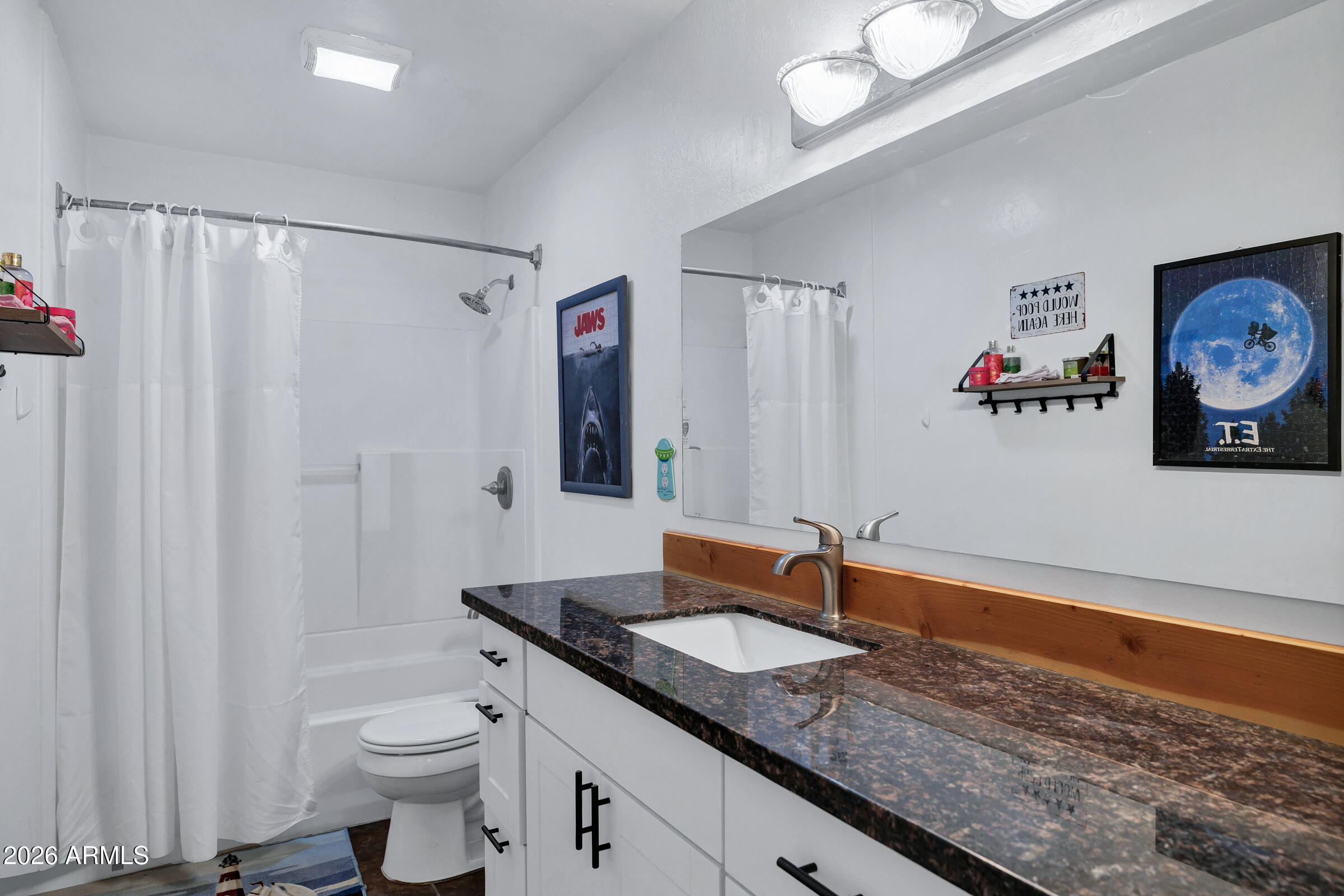 6618 North Evans Road Coolidge, AZ 85128 - Photo 25 of 48 a bathroom with a sink a toilet and a large mirror