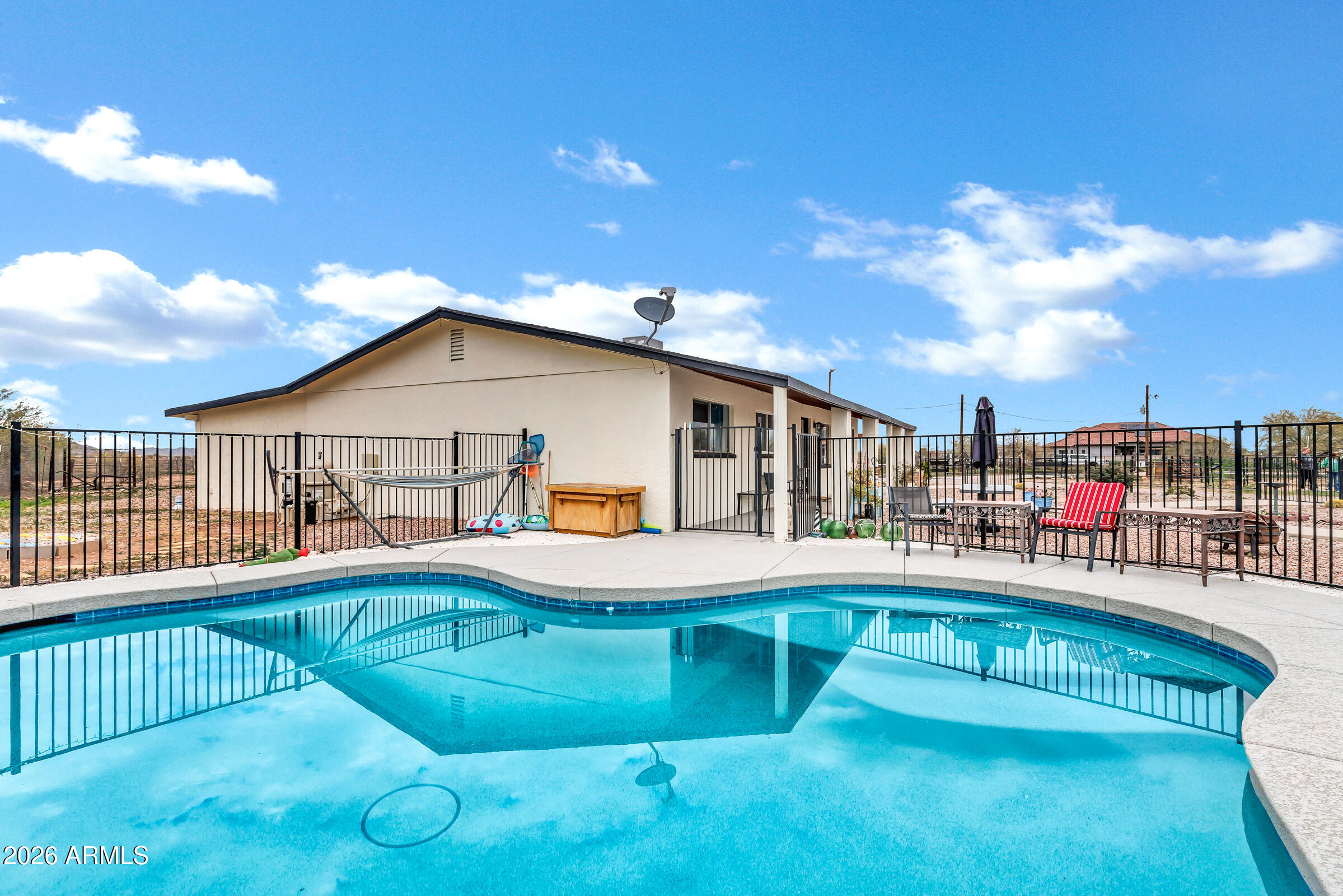 6618 North Evans Road Coolidge, AZ 85128 - Photo 29 of 48 a swimming pool with barbeque oven in front of it
